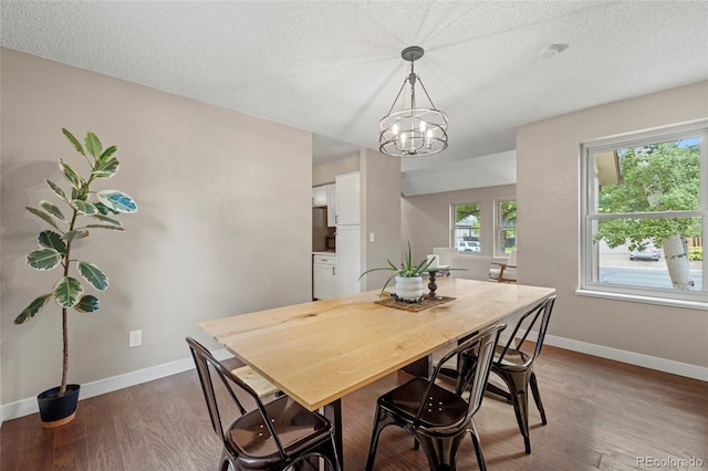 1285 Aberdeen Dr, Broomfield, CO 80020 - dining space featuring wood finished floors, baseboards, a textured ceiling, and a chandelier