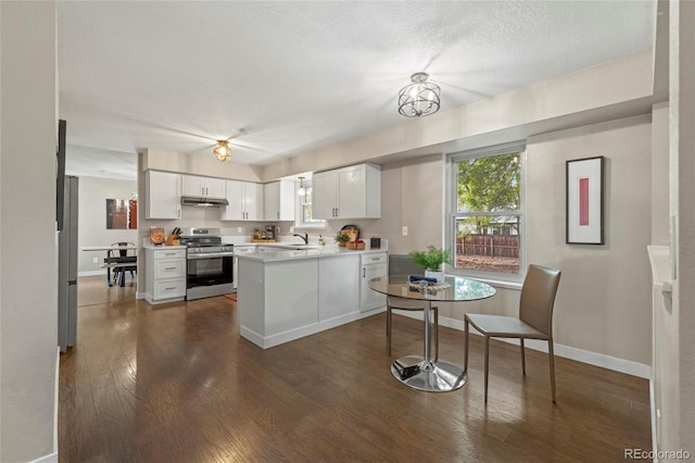 1285 Aberdeen Dr, Broomfield, CO 80020 - kitchen featuring stainless steel range oven, a sink, under cabinet range hood, a peninsula, and dark wood-style floors