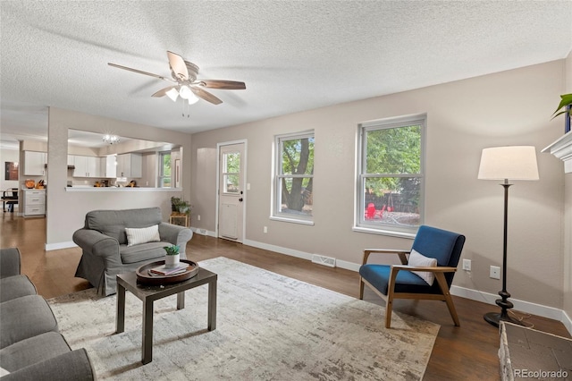 1285 Aberdeen Dr, Broomfield, CO 80020 - living area featuring a ceiling fan, wood finished floors, a textured ceiling, and baseboards