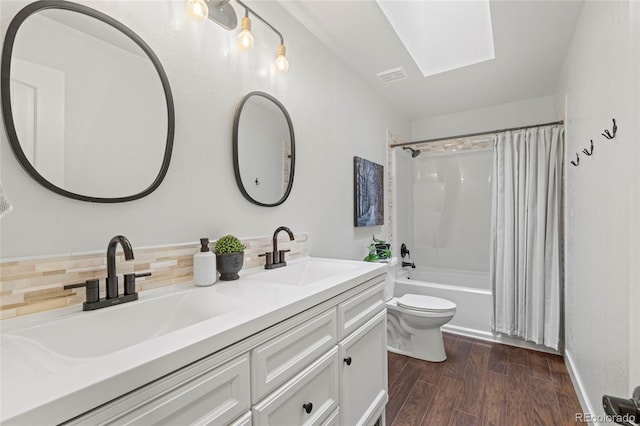 1285 Aberdeen Dr, Broomfield, CO 80020 - full bathroom with a skylight, toilet, double vanity, shower / bathtub combination with curtain, and wood finished floors