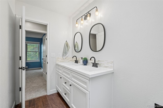 1285 Aberdeen Dr, Broomfield, CO 80020 - full bath featuring double vanity, wood finished floors, tasteful backsplash, and baseboards