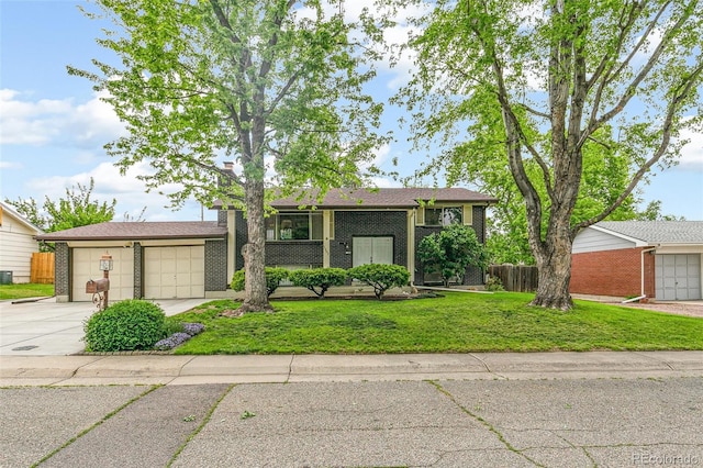 7503 Saulsbury St, Arvada, CO 80003 - view of front of home featuring driveway, an attached garage, and brick siding