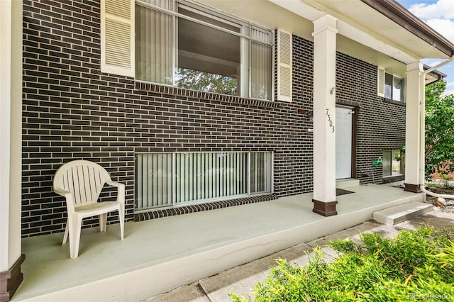 7503 Saulsbury St, Arvada, CO 80003 - view of home's exterior with brick siding and a porch