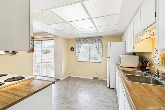 7503 Saulsbury St, Arvada, CO 80003 - kitchen featuring a sink, butcher block countertops, white appliances, white cabinets, and baseboards