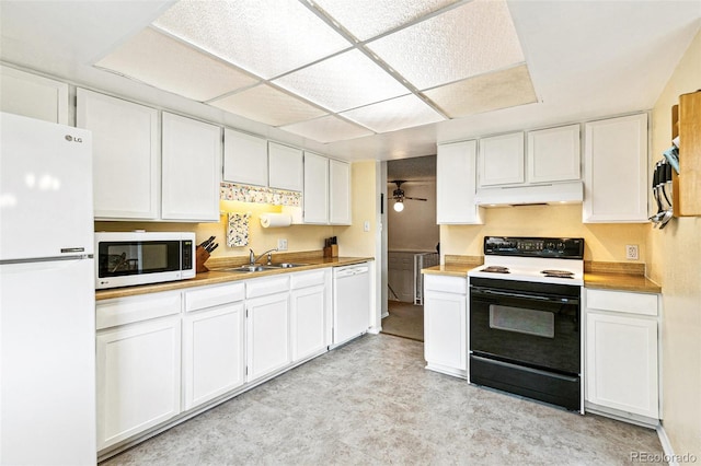 7503 Saulsbury St, Arvada, CO 80003 - kitchen featuring white appliances, under cabinet range hood, a sink, and white cabinets