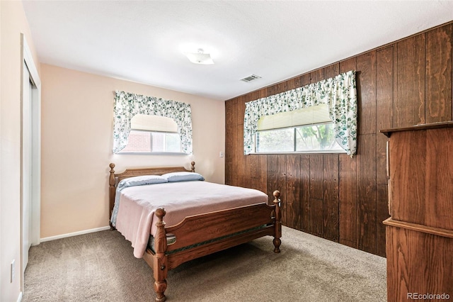 7503 Saulsbury St, Arvada, CO 80003 - bedroom with carpet and wood walls