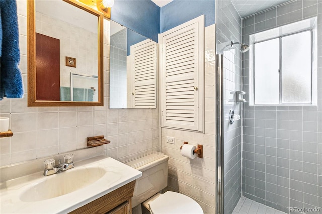 7503 Saulsbury St, Arvada, CO 80003 - full bathroom featuring a shower stall, tile walls, toilet, vanity, and backsplash