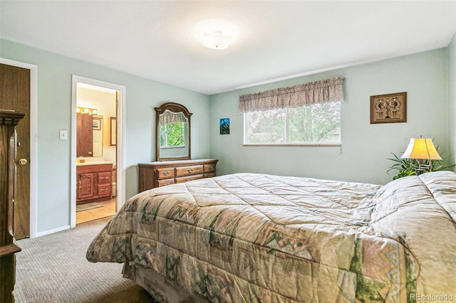 7503 Saulsbury St, Arvada, CO 80003 - bedroom featuring light carpet, ensuite bath, and baseboards