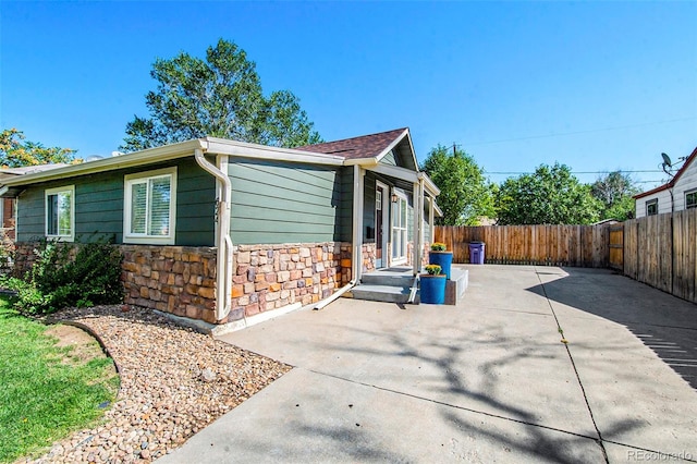 view of side of property with a patio