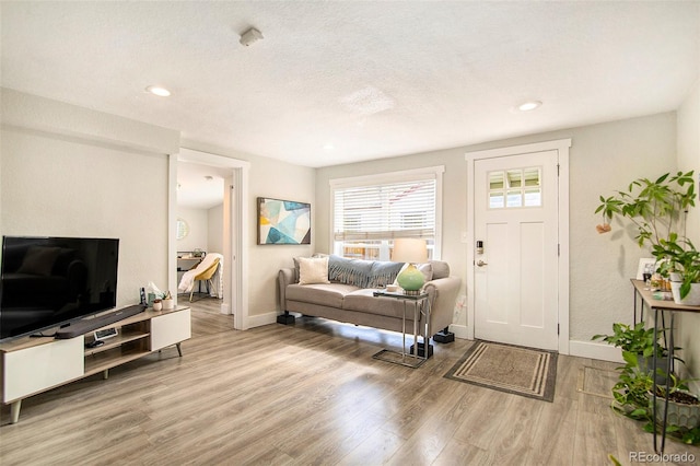 entrance foyer with light hardwood / wood-style flooring and a textured ceiling