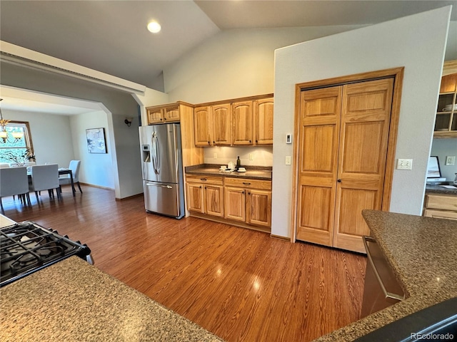 100 River Run Dr, Buena Vista, CO 81211 - kitchen with stainless steel refrigerator with ice dispenser, dark wood finished floors, a chandelier, high vaulted ceiling, and recessed lighting