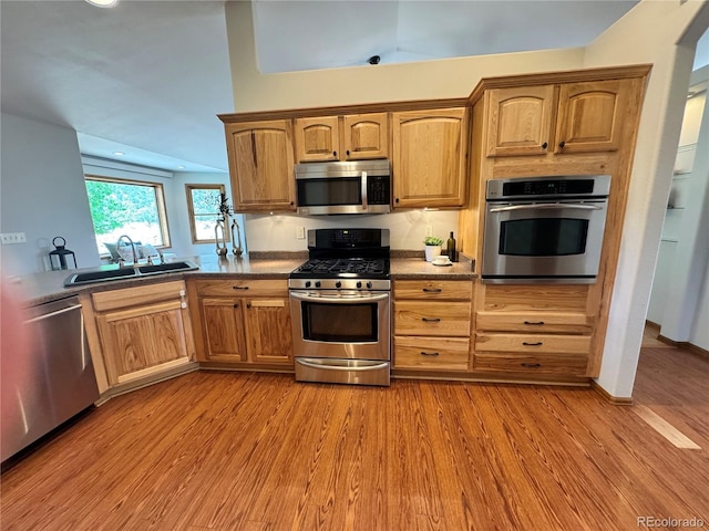 100 River Run Dr, Buena Vista, CO 81211 - kitchen featuring appliances with stainless steel finishes, a sink, light wood-style flooring, dark countertops, and recessed lighting