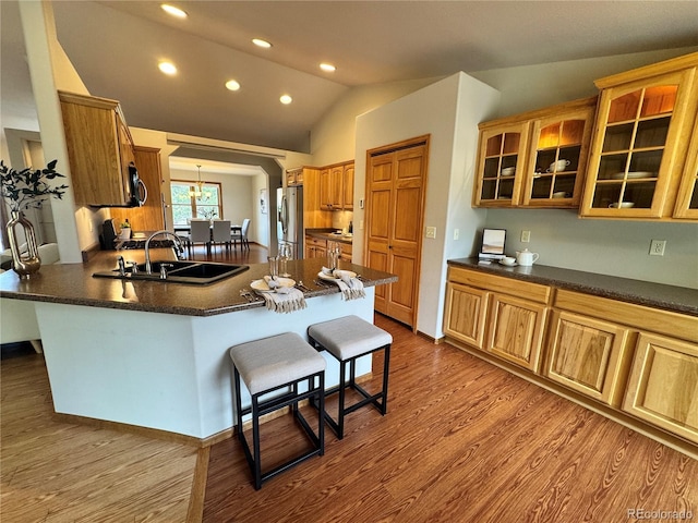 100 River Run Dr, Buena Vista, CO 81211 - kitchen with a sink, stainless steel fridge, lofted ceiling, a kitchen breakfast bar, and a peninsula