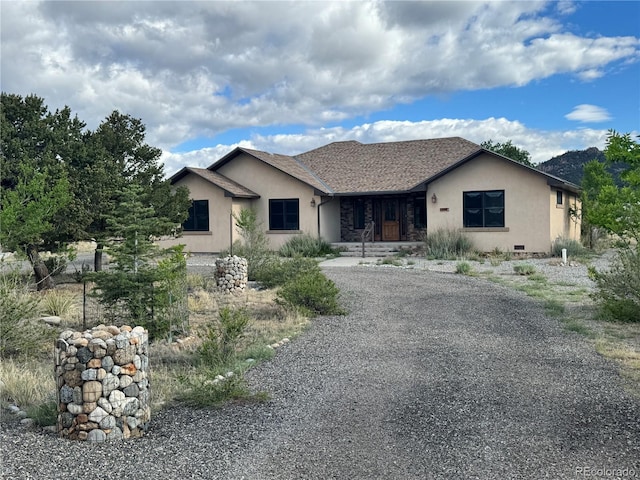 100 River Run Dr, Buena Vista, CO 81211 - ranch-style home with stucco siding, covered porch, and gravel driveway
