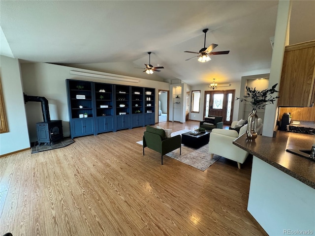 100 River Run Dr, Buena Vista, CO 81211 - living area featuring a wood stove, wood finished floors, ceiling fan, and lofted ceiling