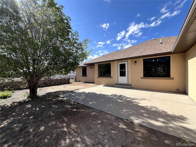 100 River Run Dr, Buena Vista, CO 81211 - back of property with stucco siding and a patio