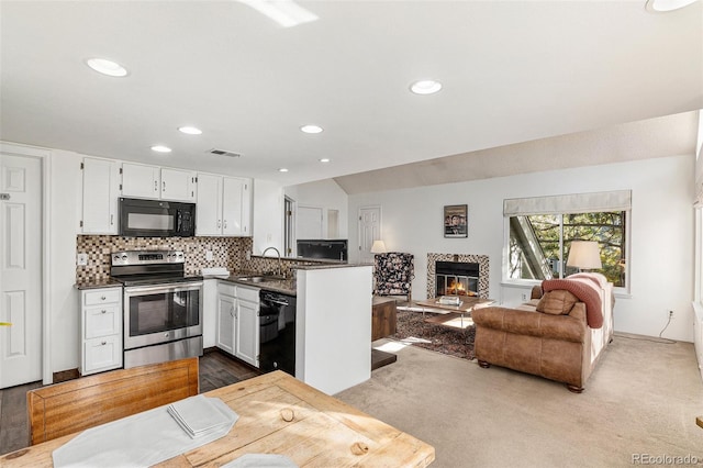 kitchen featuring white cabinetry, black appliances, sink, and light carpet