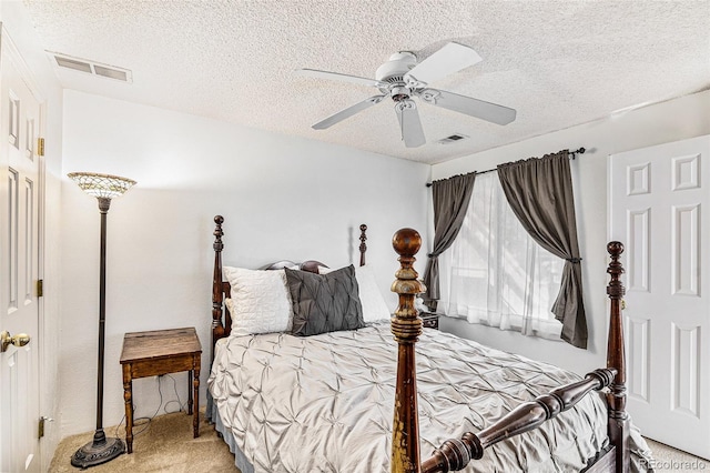 carpeted bedroom with a textured ceiling and ceiling fan