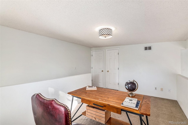 office area featuring carpet and a textured ceiling