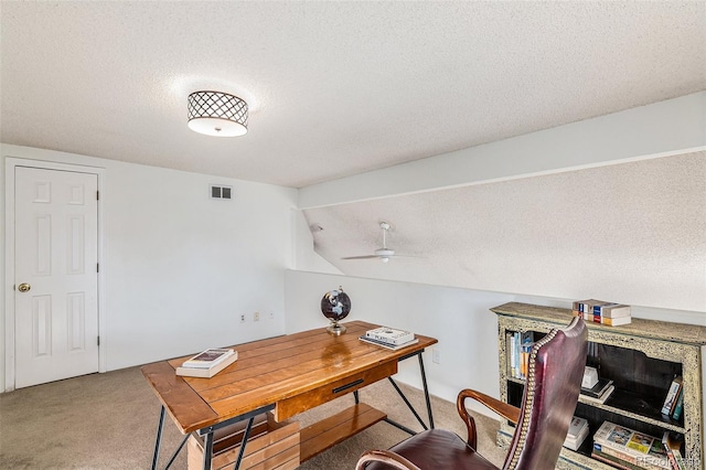 office area with lofted ceiling, ceiling fan, carpet, and a textured ceiling