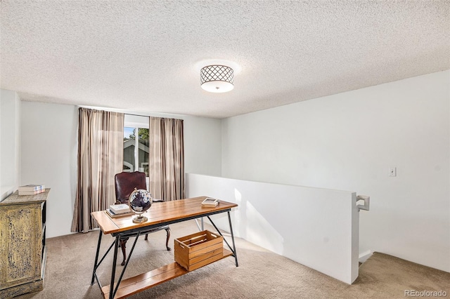 office with carpet floors and a textured ceiling