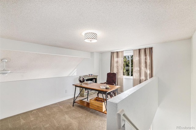 carpeted office with ceiling fan and a textured ceiling