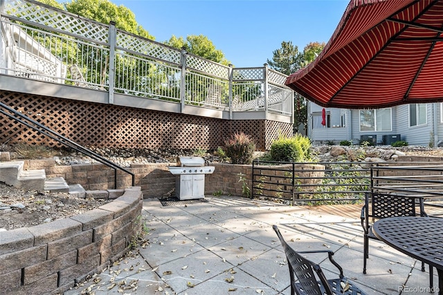 view of patio / terrace with area for grilling and a wooden deck