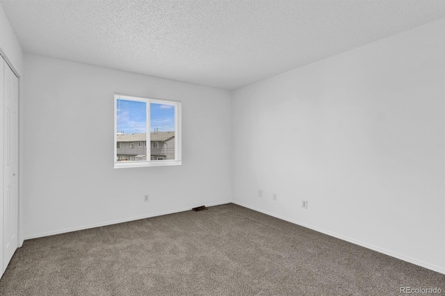 1287 Soaring Eagle Dr, Colorado Springs, CO 80915 - unfurnished bedroom with carpet, a textured ceiling, a closet, and baseboards