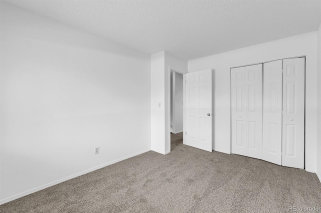 1287 Soaring Eagle Dr, Colorado Springs, CO 80915 - unfurnished bedroom featuring carpet flooring, baseboards, a textured ceiling, and a closet
