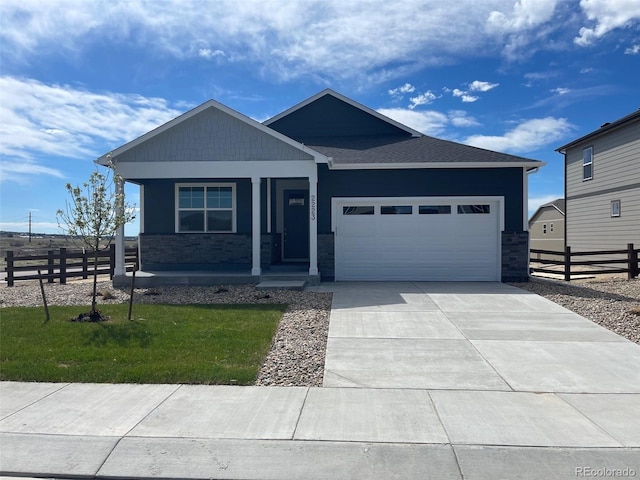 view of front of home featuring a garage and a front lawn