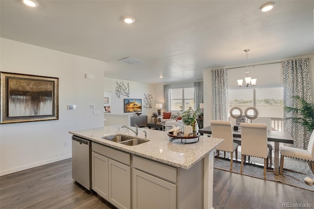 kitchen featuring dishwasher, sink, hanging light fixtures, dark hardwood / wood-style floors, and a notable chandelier