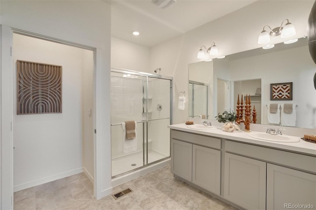 bathroom with tile patterned floors, vanity, and a shower with shower door