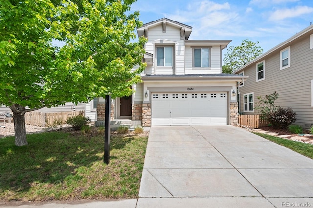 10681 Cherrybrook Cir, Highlands Ranch, CO 80126 - view of front of property featuring stone siding, an attached garage, and driveway