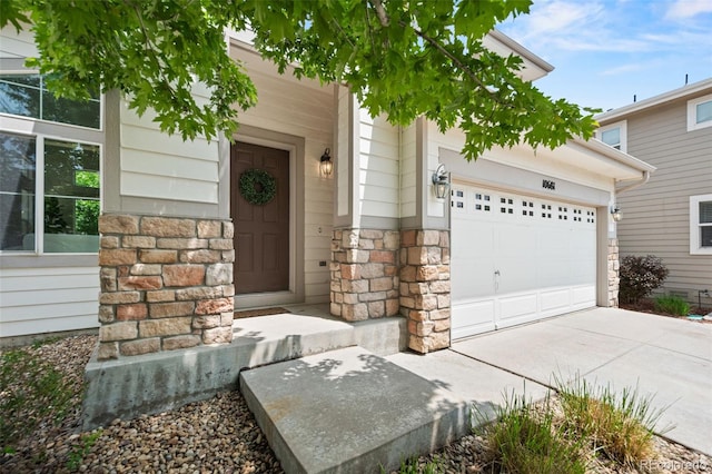 10681 Cherrybrook Cir, Highlands Ranch, CO 80126 - doorway to property featuring stone siding, concrete driveway, and an attached garage