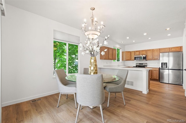 10681 Cherrybrook Cir, Highlands Ranch, CO 80126 - dining room featuring healthy amount of natural light, a chandelier, recessed lighting, light wood-type flooring, and baseboards