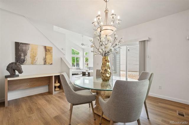 10681 Cherrybrook Cir, Highlands Ranch, CO 80126 - dining area with a chandelier, wood finished floors, baseboards, and ceiling fan