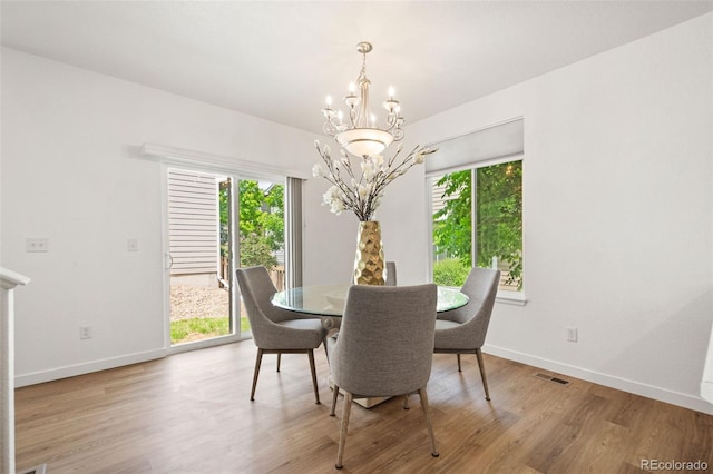 10681 Cherrybrook Cir, Highlands Ranch, CO 80126 - dining area featuring a chandelier, healthy amount of natural light, light wood-style floors, and baseboards