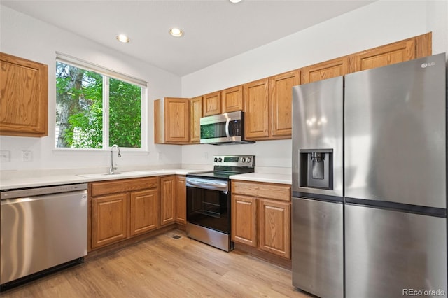 10681 Cherrybrook Cir, Highlands Ranch, CO 80126 - kitchen featuring appliances with stainless steel finishes, a sink, light wood finished floors, light countertops, and recessed lighting