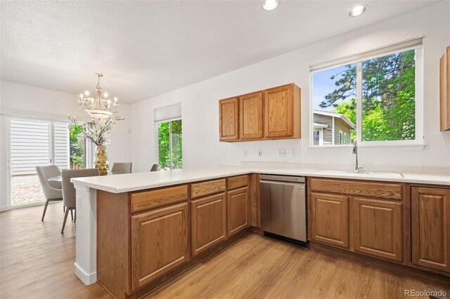 10681 Cherrybrook Cir, Highlands Ranch, CO 80126 - kitchen with dishwasher, a sink, light wood-style flooring, a peninsula, and recessed lighting