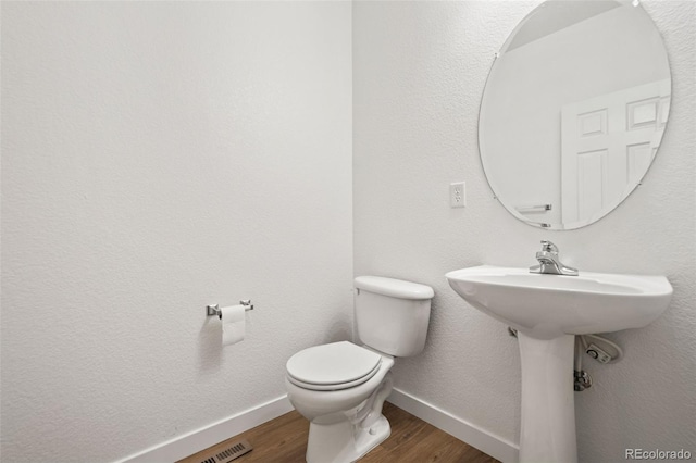 10681 Cherrybrook Cir, Highlands Ranch, CO 80126 - bathroom featuring wood finished floors, baseboards, and toilet