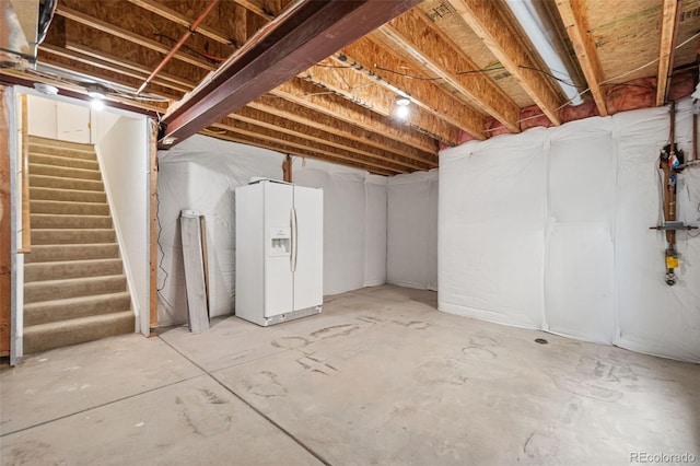 10681 Cherrybrook Cir, Highlands Ranch, CO 80126 - unfinished basement featuring white refrigerator with ice dispenser and stairway