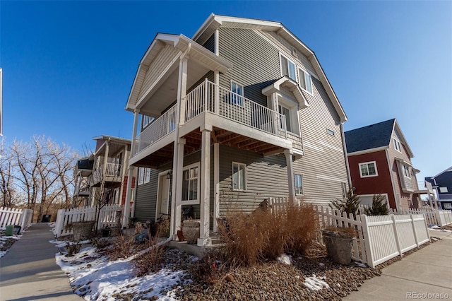 view of snowy exterior featuring a balcony