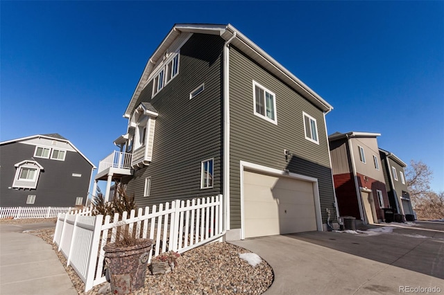 view of property exterior with a garage and central AC