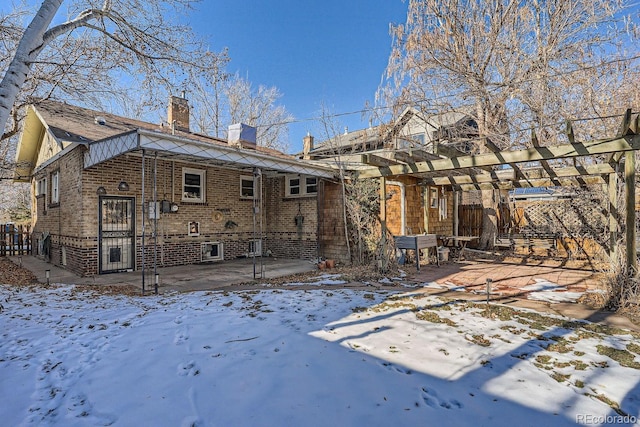 snow covered property featuring a patio and a pergola