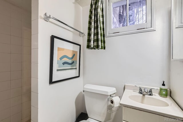 bathroom featuring toilet and vanity