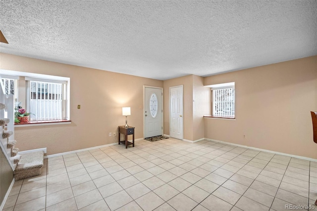 tiled entrance foyer with a textured ceiling