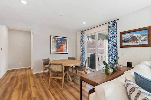 dining space featuring light wood finished floors, baseboards, and recessed lighting