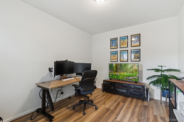 home office with wood finished floors and baseboards