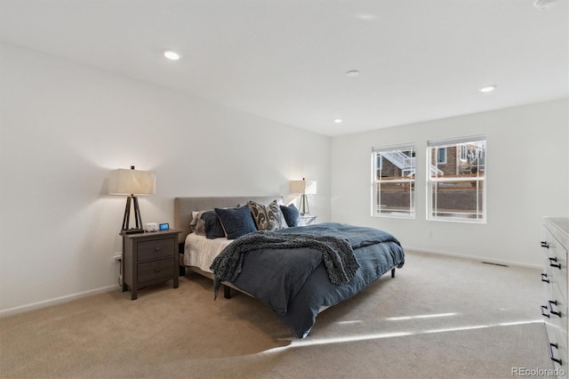 bedroom featuring recessed lighting, light carpet, and baseboards