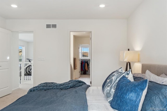 bedroom with multiple windows, recessed lighting, visible vents, and light colored carpet